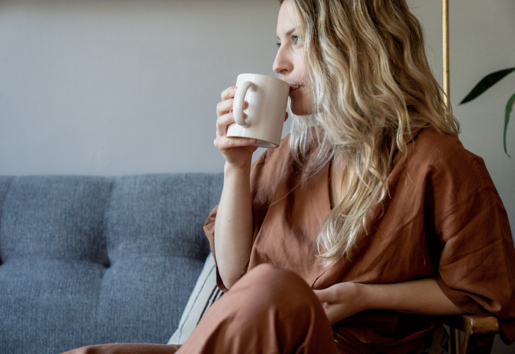 Perimenopause woman sipping tea in a calm setting (1)
